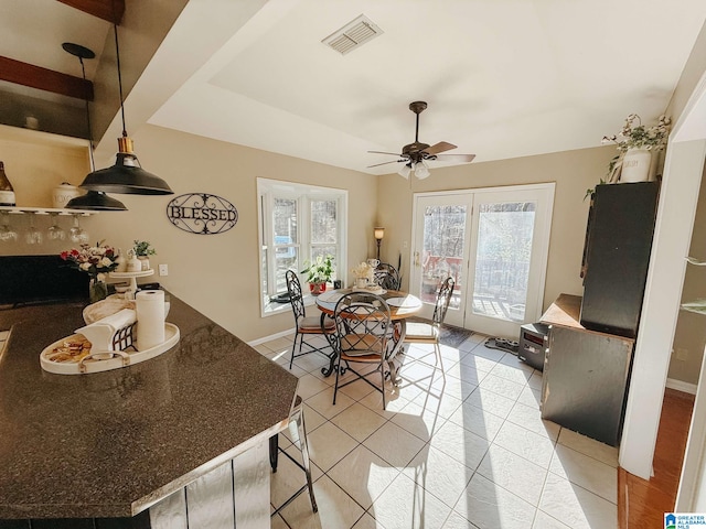 dining room with ceiling fan, light tile patterned flooring, visible vents, and baseboards