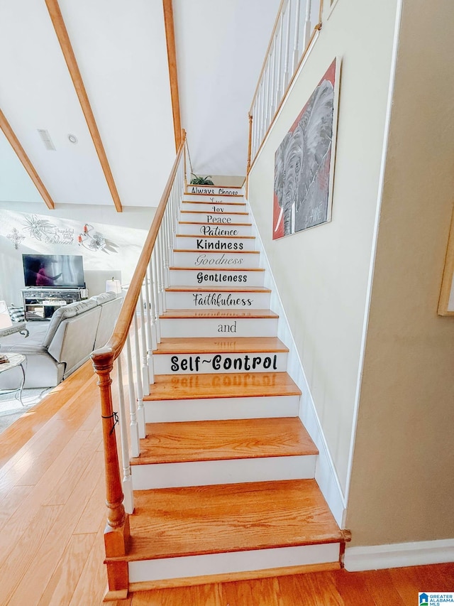 stairs featuring beam ceiling, visible vents, baseboards, and wood finished floors