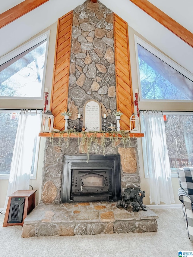 interior details featuring a wood stove, carpet flooring, and beamed ceiling