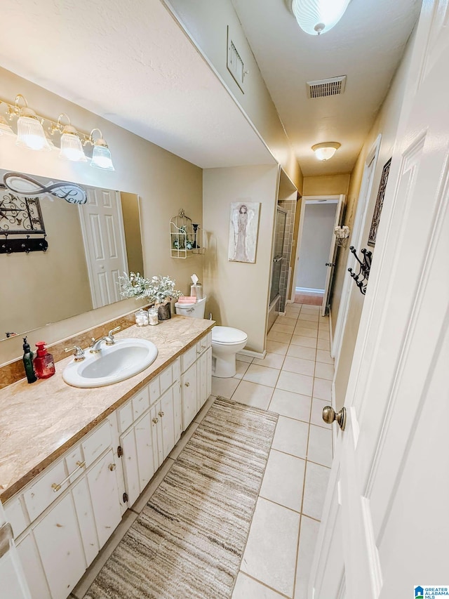 full bathroom featuring tile patterned flooring, toilet, vanity, visible vents, and a shower stall