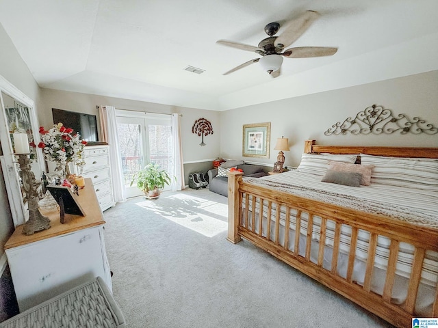 bedroom featuring a ceiling fan, visible vents, and carpet flooring