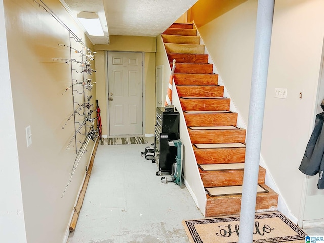 stairs with baseboards and unfinished concrete flooring