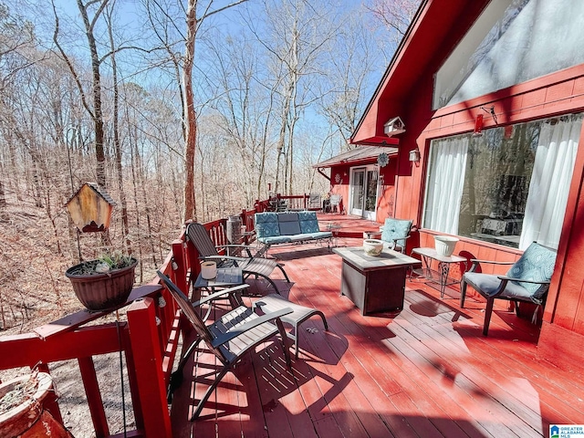 wooden terrace with an outdoor hangout area