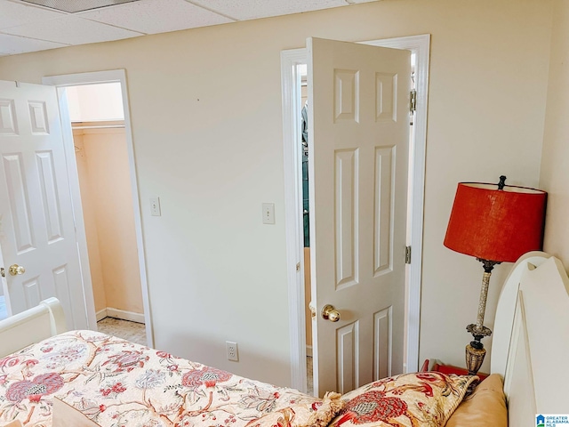 bedroom featuring a paneled ceiling and a closet