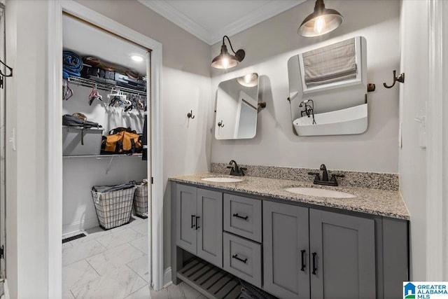 full bath with crown molding, marble finish floor, a sink, and a spacious closet