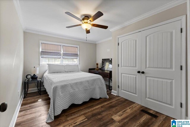 bedroom with visible vents, baseboards, ornamental molding, a closet, and dark wood-style floors