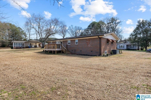 back of house with a wooden deck, central AC unit, crawl space, a yard, and brick siding