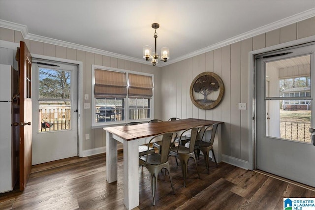 dining space with ornamental molding, wood finished floors, and a wealth of natural light