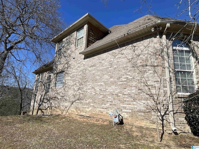 view of side of home with brick siding