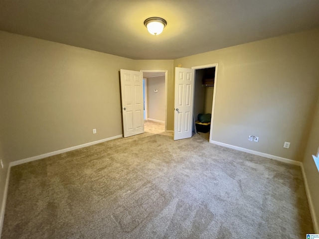 unfurnished bedroom with a closet, baseboards, and carpet floors