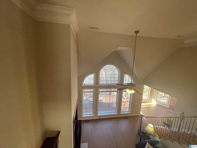 interior space with visible vents, high vaulted ceiling, ceiling fan, and wood finished floors