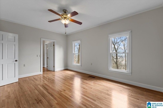 unfurnished bedroom featuring crown molding, ceiling fan, baseboards, and light wood-style floors