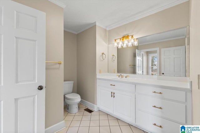 bathroom with crown molding, toilet, vanity, baseboards, and tile patterned floors