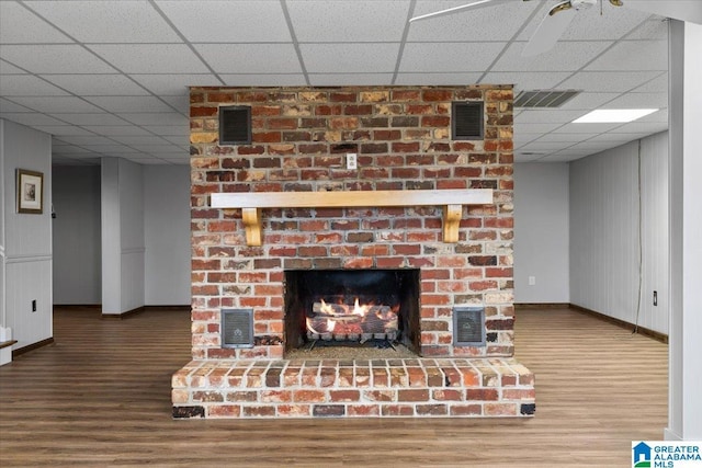 interior details with visible vents, a fireplace, and wood finished floors