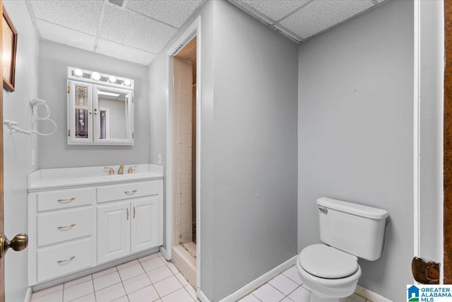 full bathroom with toilet, a shower stall, vanity, tile patterned flooring, and a drop ceiling