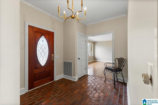 foyer entrance with brick floor, baseboards, visible vents, and ornamental molding