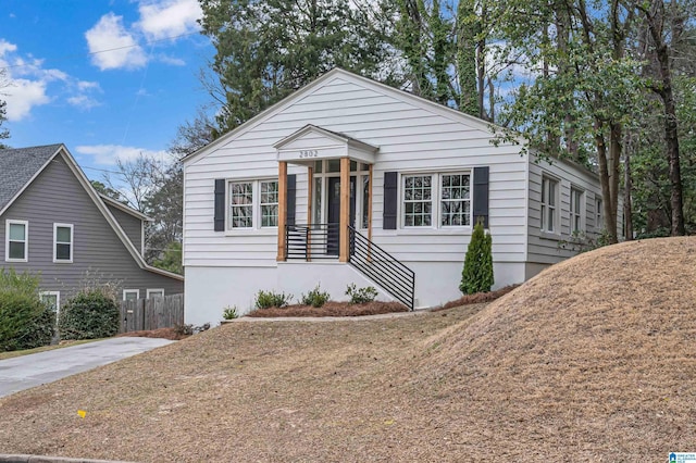 bungalow-style home with fence