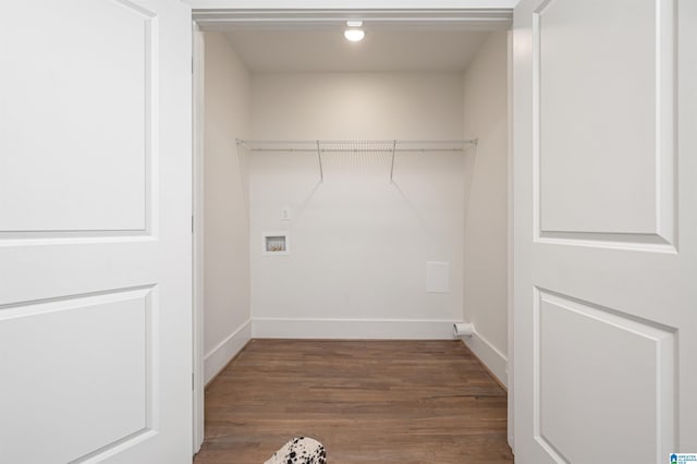 clothes washing area featuring hookup for a washing machine, baseboards, and wood finished floors