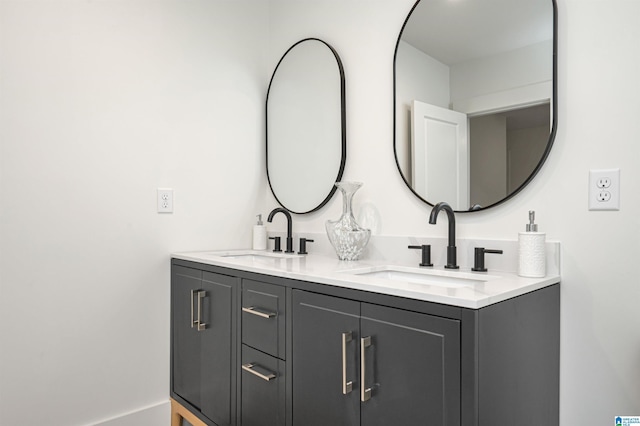 bathroom with a sink and double vanity