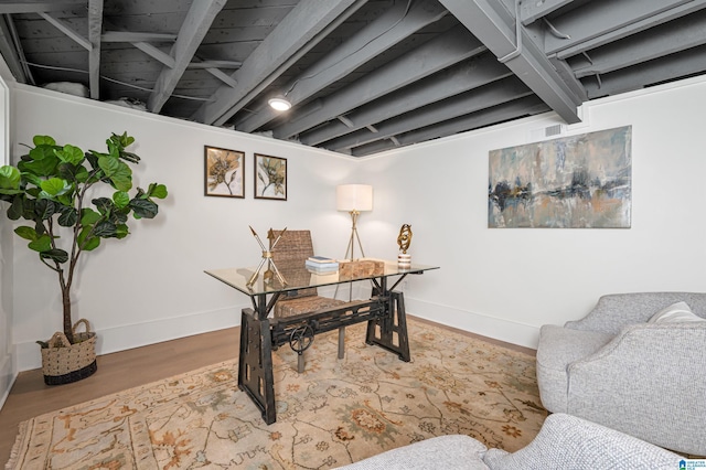 office area featuring visible vents, baseboards, and wood finished floors