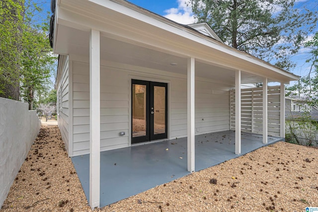 exterior space with french doors and fence