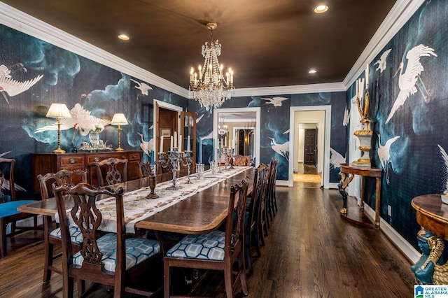 dining room featuring baseboards, ornamental molding, wood finished floors, and an inviting chandelier