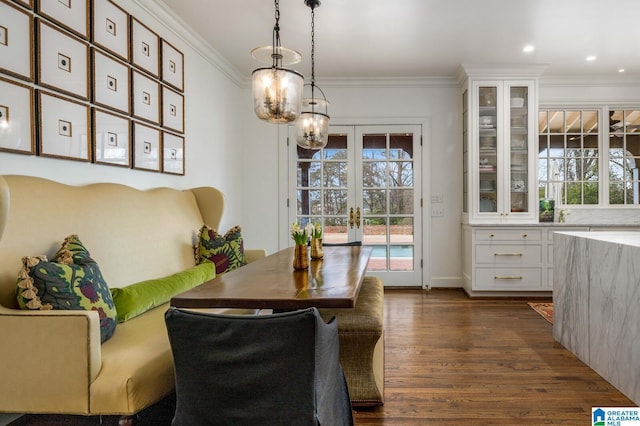 dining room with ornamental molding, dark wood-style flooring, and french doors