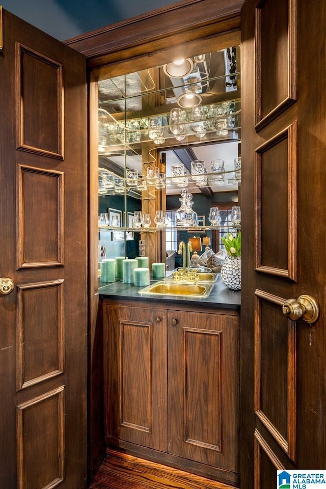 bar featuring indoor wet bar and a sink