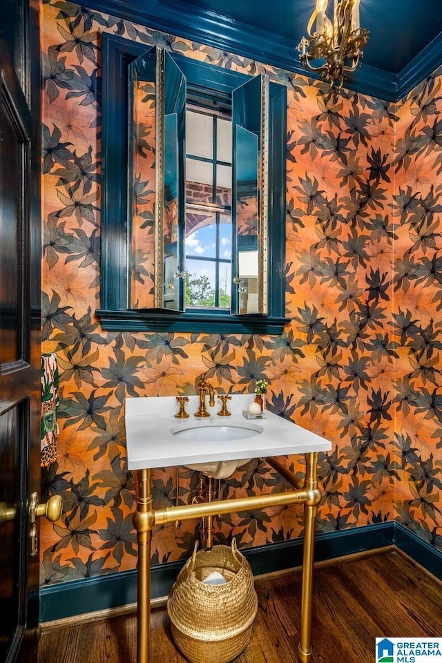 unfurnished dining area featuring crown molding, baseboards, an inviting chandelier, and wallpapered walls