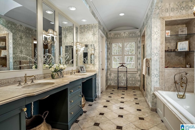 bathroom with a sink, wallpapered walls, a tub, and crown molding