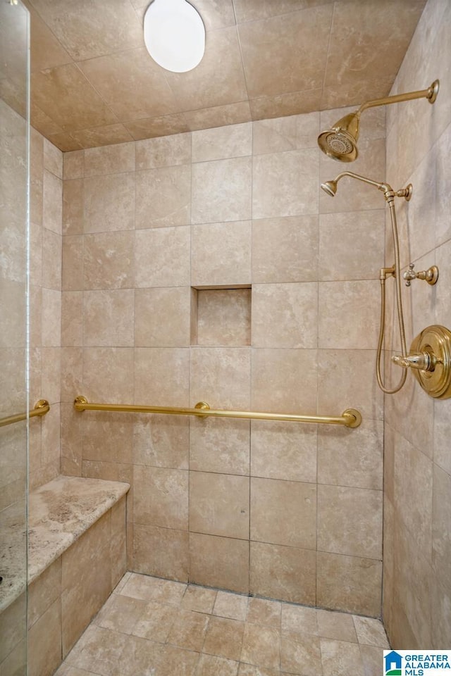 full bathroom with a tile shower