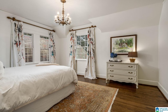 bedroom with a chandelier, baseboards, and wood finished floors