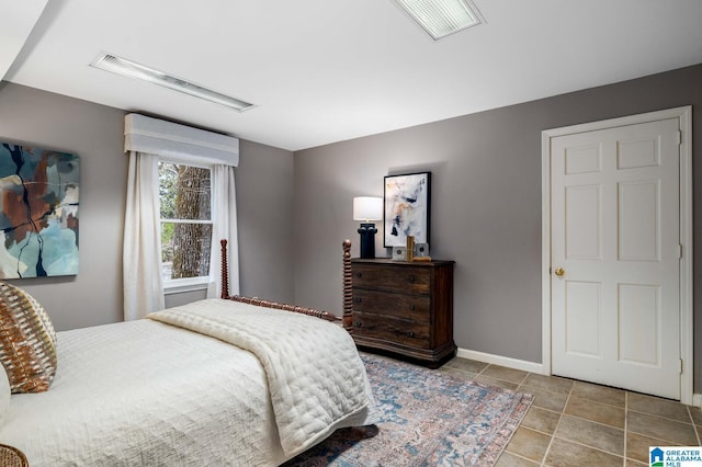 tiled bedroom with visible vents and baseboards