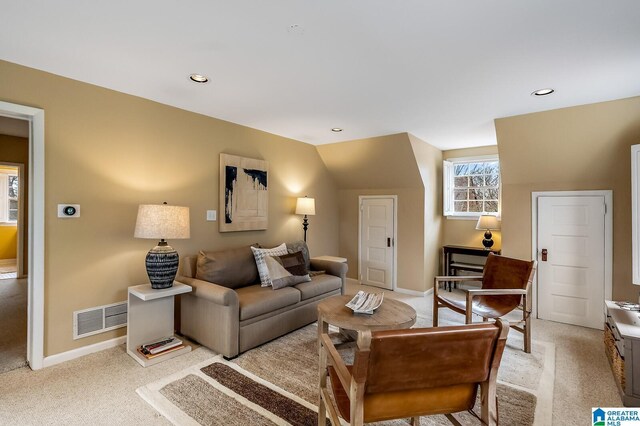 living area featuring light carpet, baseboards, visible vents, and recessed lighting