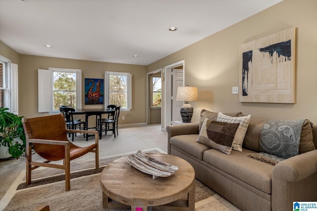 living room with recessed lighting, baseboards, and light colored carpet