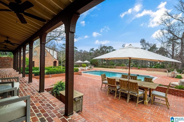 view of patio / terrace featuring a ceiling fan, outdoor dining area, and an outdoor pool