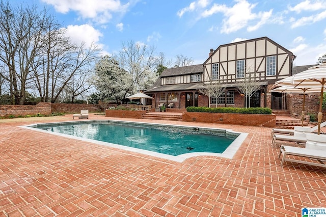 outdoor pool featuring a patio area