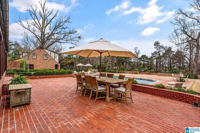 view of patio / terrace with a swimming pool and outdoor dining area