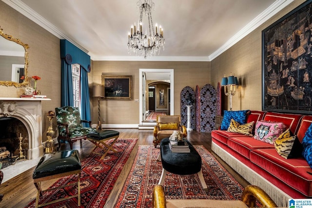 living room with a chandelier, arched walkways, a fireplace, wood finished floors, and crown molding