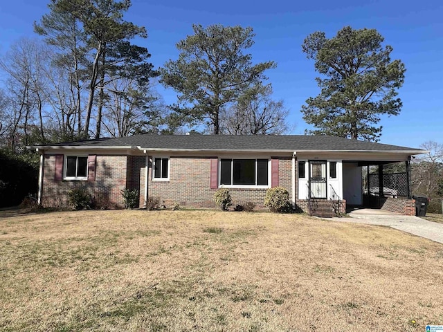 ranch-style home with a shingled roof, a front yard, concrete driveway, and brick siding