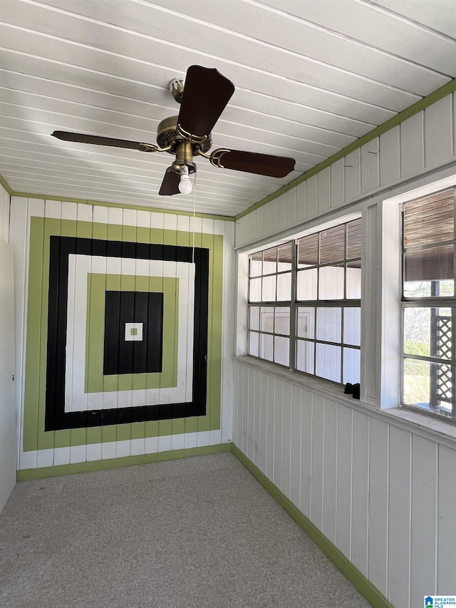 unfurnished sunroom with ceiling fan