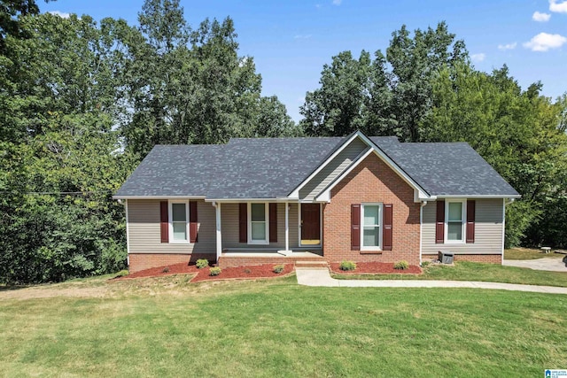 ranch-style house with a front yard and roof with shingles