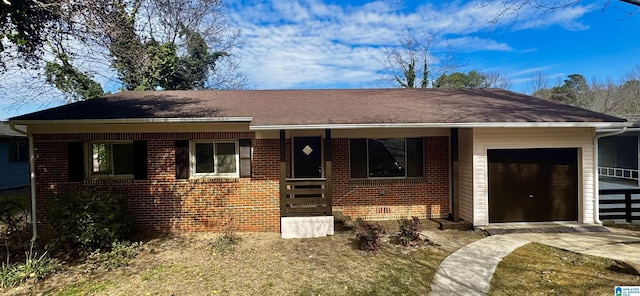 ranch-style home featuring a garage, brick siding, and covered porch