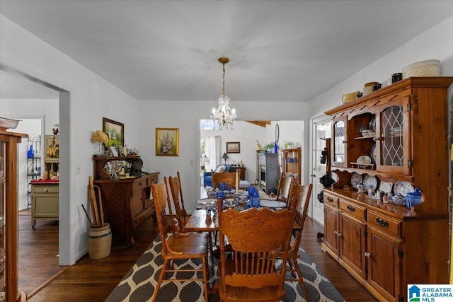 dining room featuring a chandelier and dark wood-style flooring