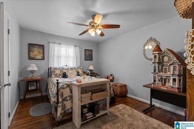 bedroom featuring wood finished floors, a ceiling fan, and baseboards