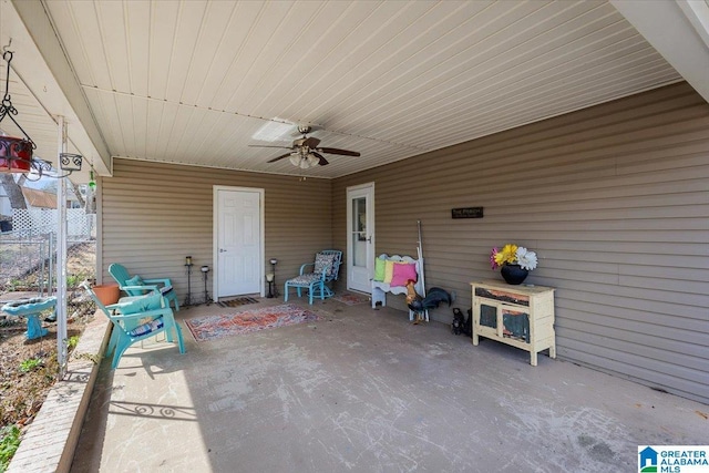 view of patio with a ceiling fan and fence