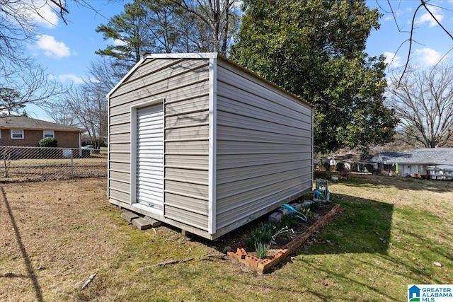 view of shed featuring fence