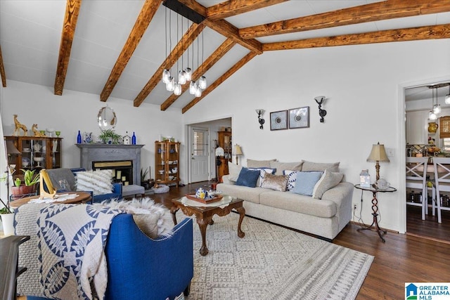 living area with a chandelier, wood finished floors, beamed ceiling, a fireplace, and high vaulted ceiling