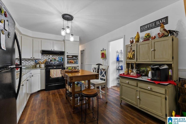 kitchen featuring dark wood-style floors, light countertops, decorative backsplash, under cabinet range hood, and black appliances