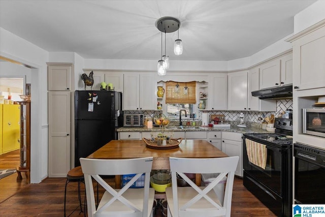 kitchen with black appliances, under cabinet range hood, dark wood finished floors, and a sink